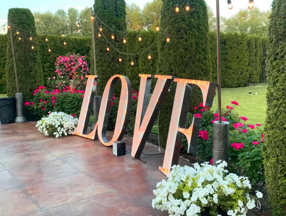 Illuminated LOVE sign with garden florals