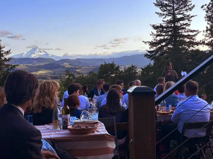 Outdoor wedding toast at golden hour with mountain view